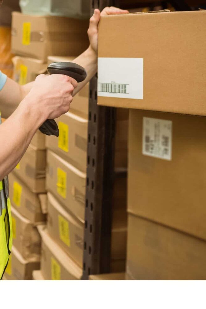 Person scanning box in a warehouse